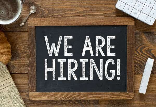 Wooden Sign With the Words We Are Hiring
